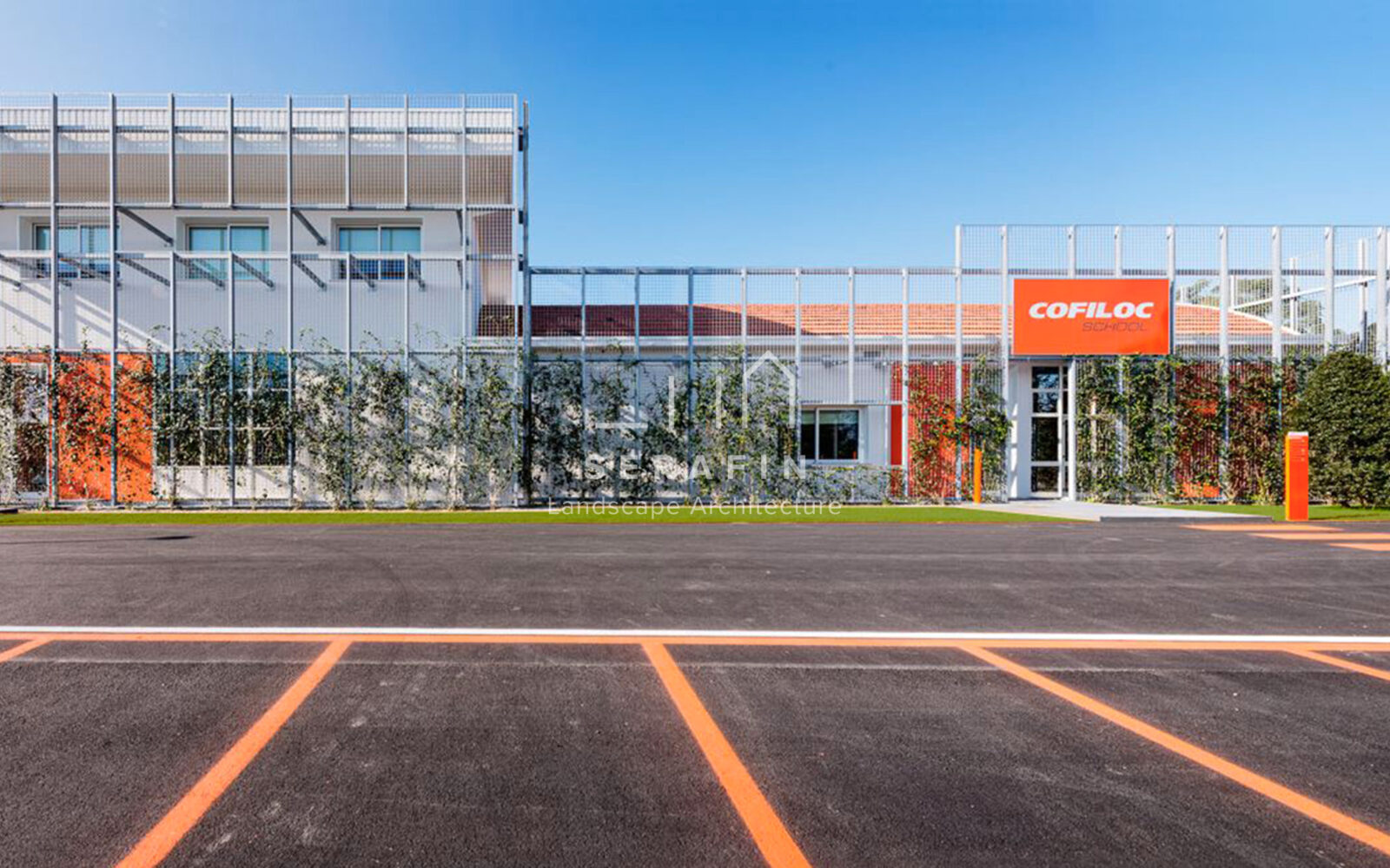 corporate green space with lawn, flower beds and a vertical green wall - 1